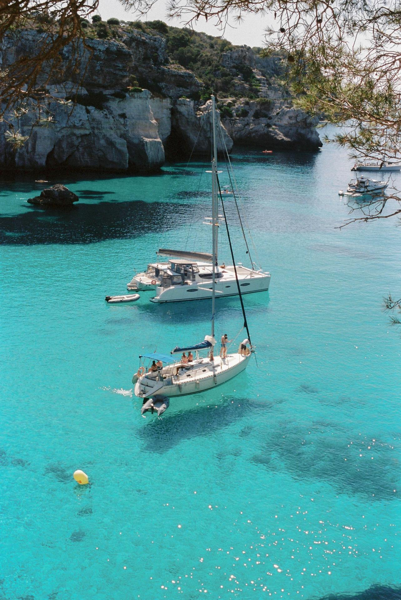Boats in turquoise water in Menorca